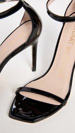 Stuart Weitzman Women's Nudist Curve 100 Patent Sandals, Black, 7 Medium US